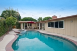 L-shaped floor plan surrounds the pool.